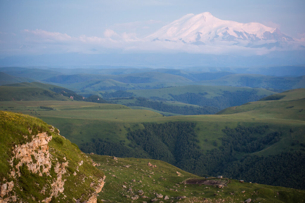 snowy peak of Mount Elbrus on background of green foothills. beautiful natural mountain landscape.
