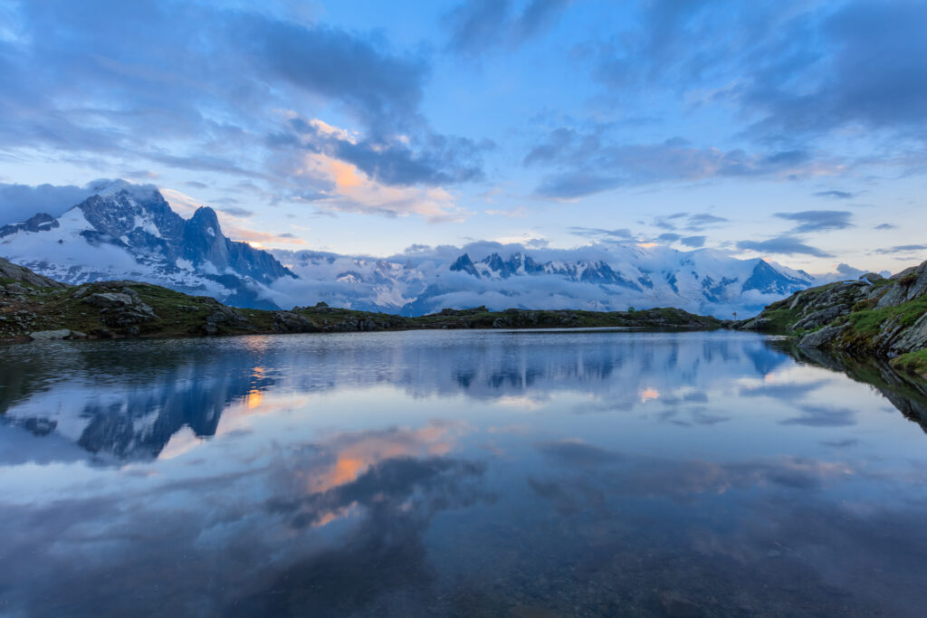 Mountains and sky reflected in Lac De Cheserys, Chamonix, France.