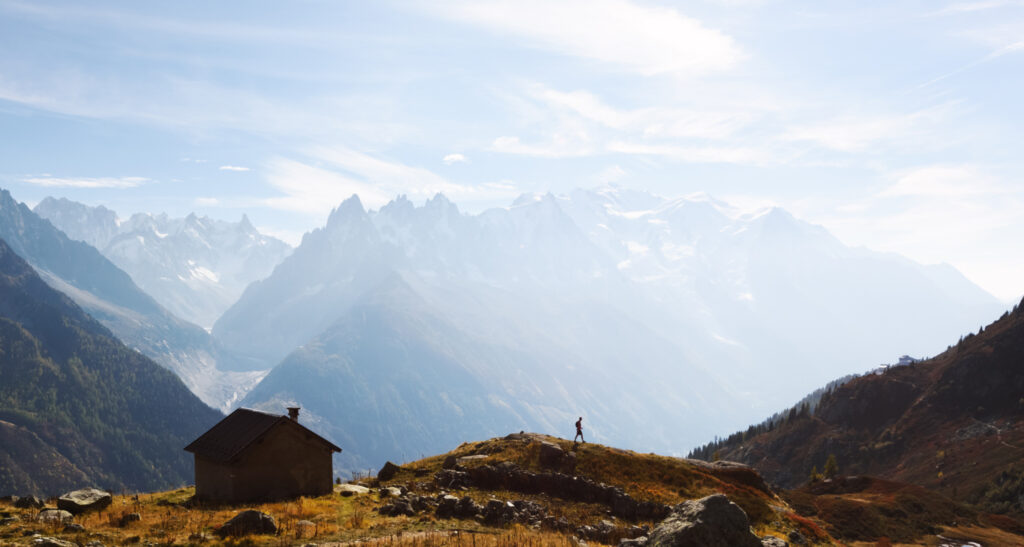 Amazing view on Monte Bianco mountains range with cabin and tourist on a foreground. Vallon de Berard Nature Preserve, Chamonix, Graian Alps. Landscape photography