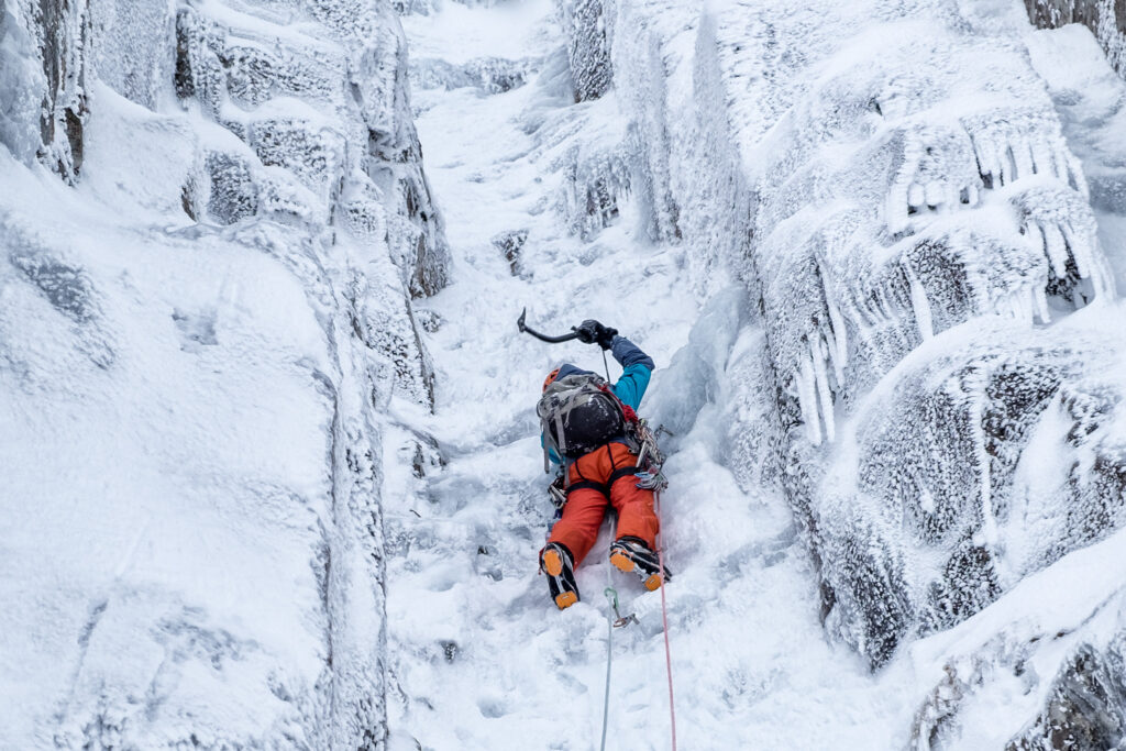 Scotland, Anoach Mor, Man ice climbing in winter