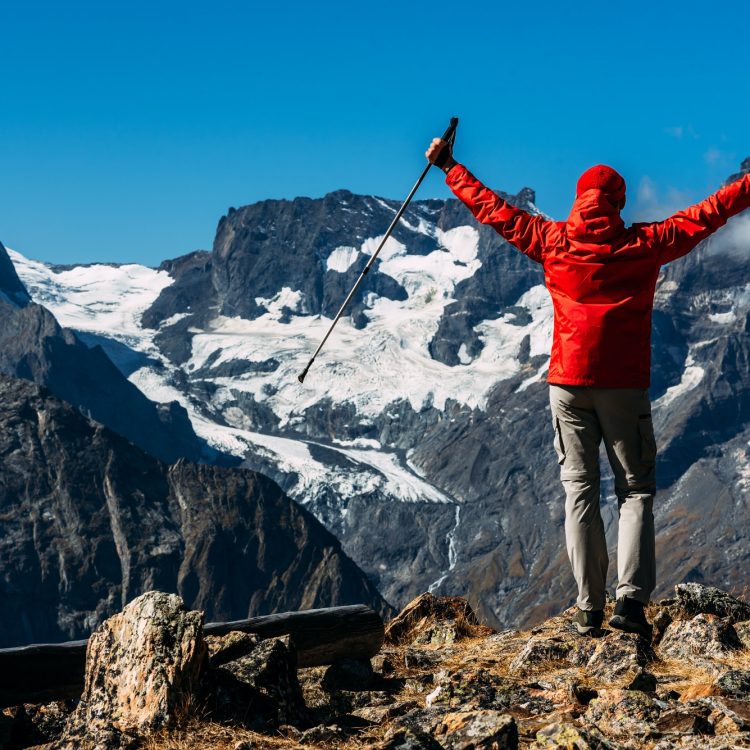 A man traveling in the Caucasus. Mountain sports. Athlete happy finish. Mountain tourism